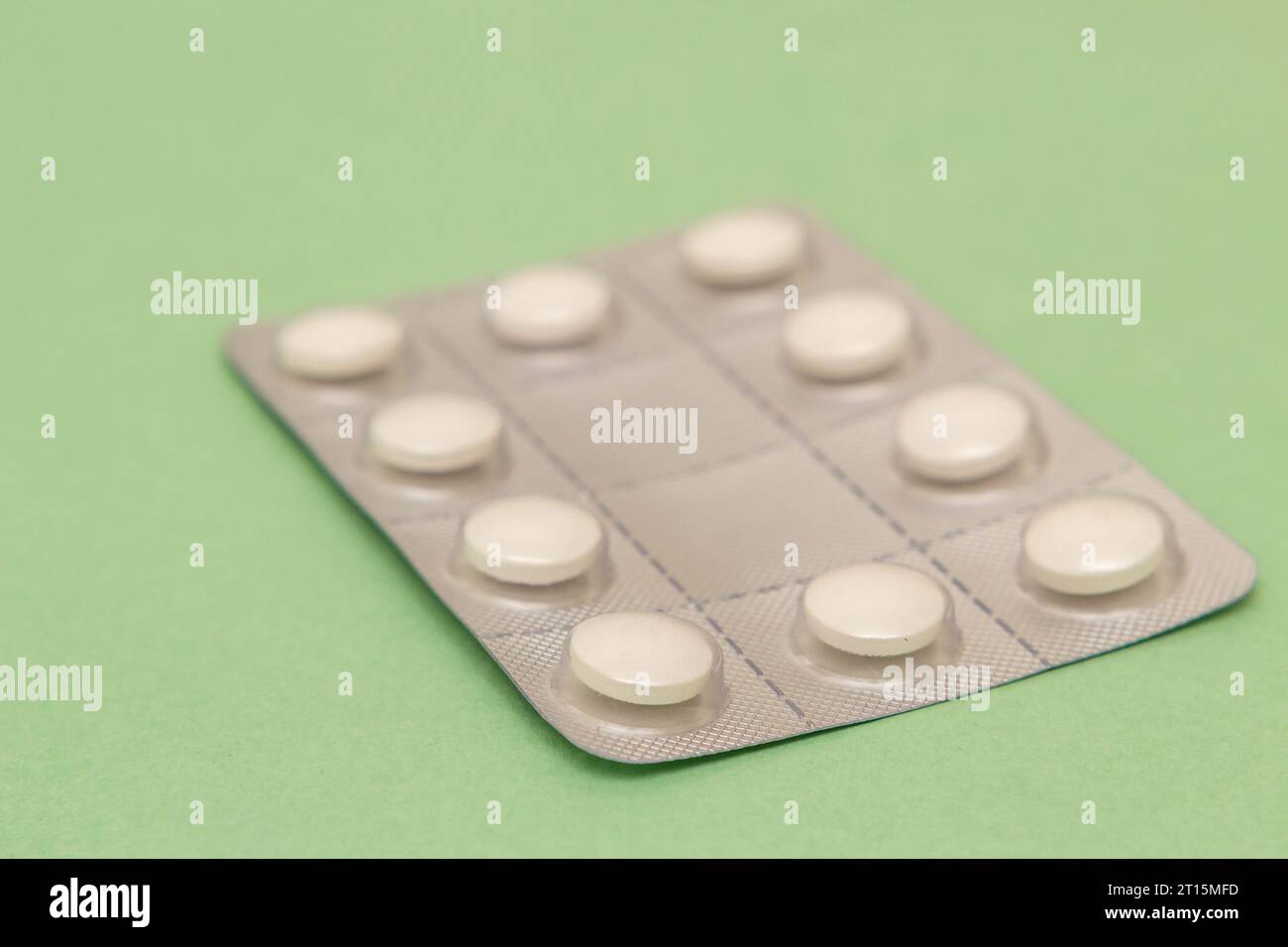 Goiânia, Goias, Brasile – 10 ottobre 2023: Un blister di plastica e alluminio con compresse su una superficie verde. Foto Stock