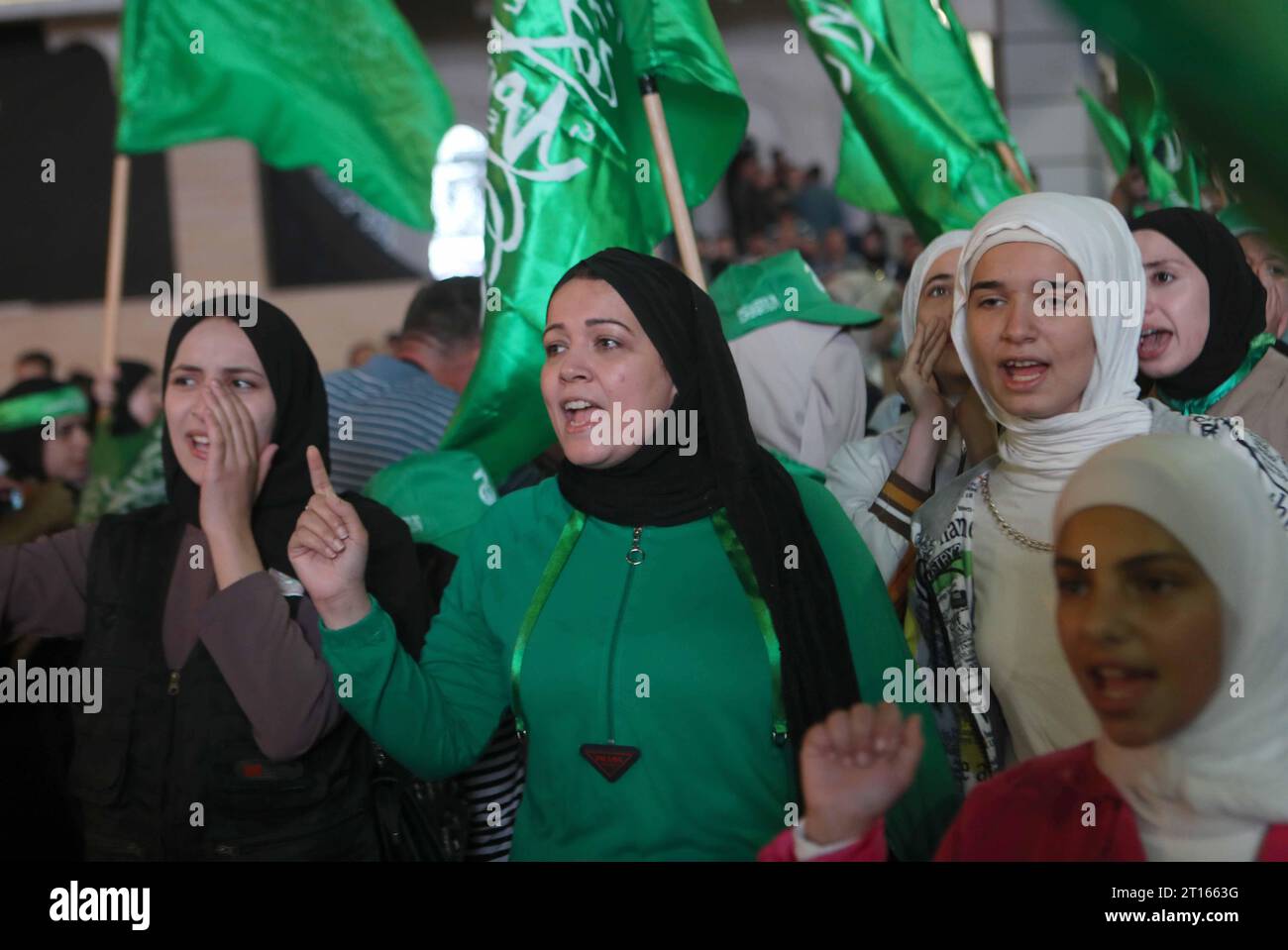 I palestinesi sventolano bandiere nazionali e Hamas gridano slogan durante la manifestazione per sostenere i movimenti di Hamas i palestinesi sventolano bandiere nazionali e Hamas gridano slogan durante la manifestazione per sostenere i movimenti di Hamas e la resistenza palestinese, l'11 ottobre 2023 a Hebron. Diversi palestinesi sono stati uccisi in scontri con le forze israeliane nella Cisgiordania occupata dall'inizio dell'offensiva di Hamas da Gaza contro Israele il 7 ottobre, con il movimento islamico che invita i combattenti della resistenza in tutti i territori palestinesi e nelle nazioni arabe e islamiche ad unirsi alla sua operazione alluvione al-Aqsa . Foto di Mamoun Wazwa Foto Stock