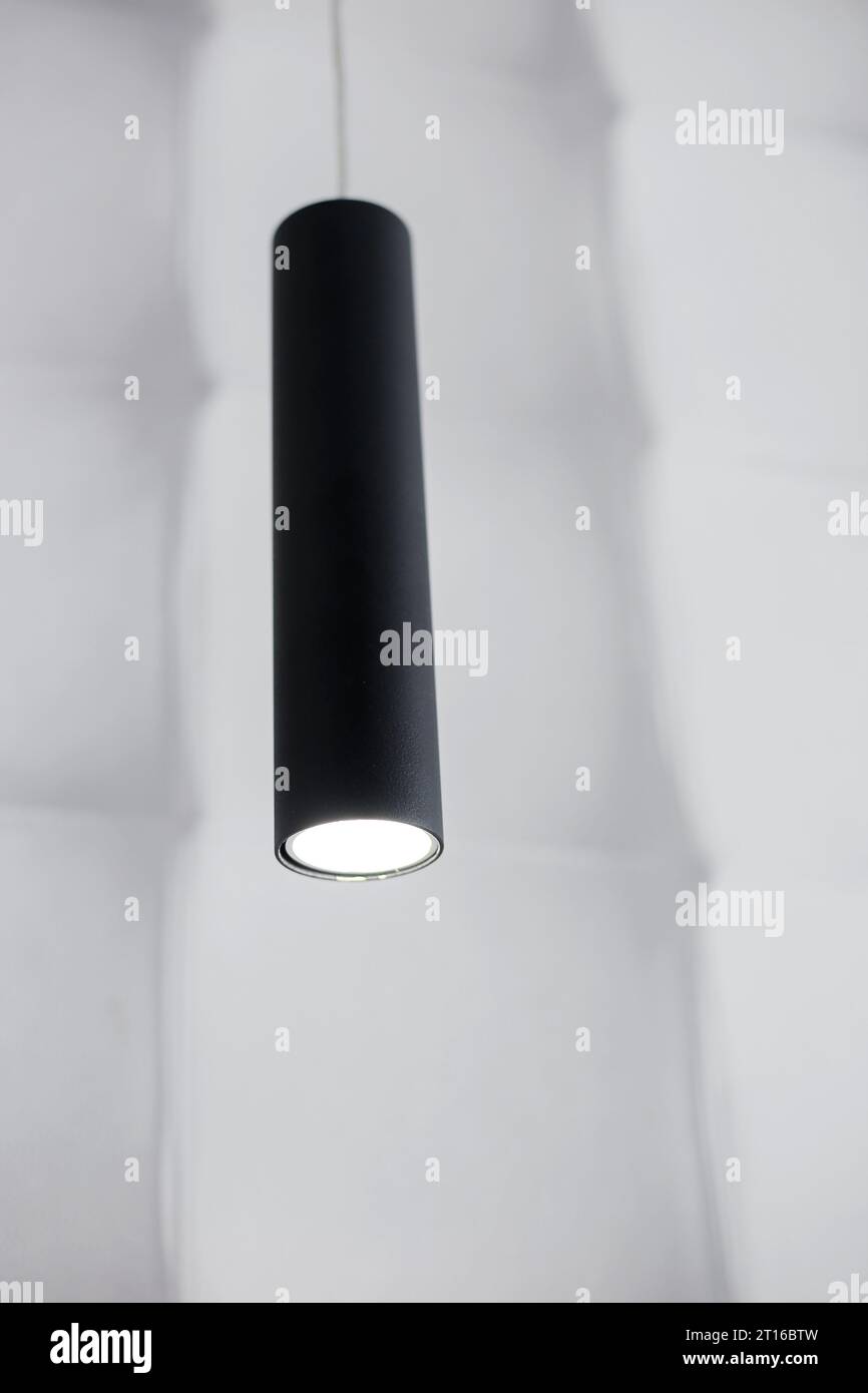 Moderna lampada a LED nera sospesa a primo piano dal soffitto Foto Stock