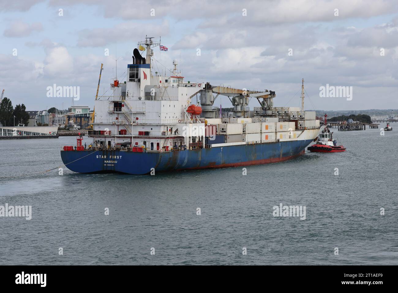 Un rimorchiatore si prepara a portare la nave da carico refrigerata MV STAR PER PRIMA nel porto internazionale Foto Stock