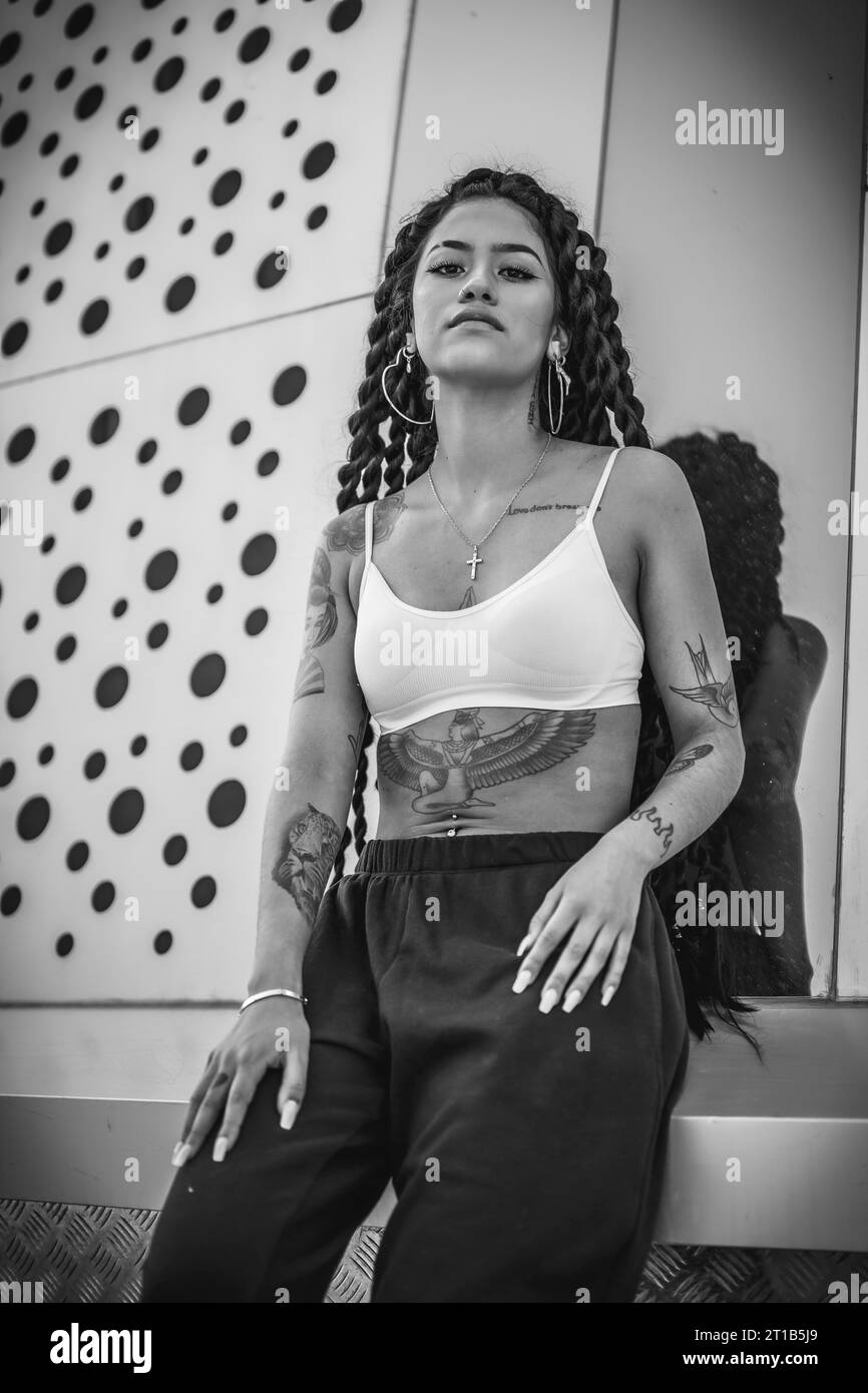 Giovane donna di etnia nera con lunghe trecce e tatuaggi, foto in bianco e nero Foto Stock