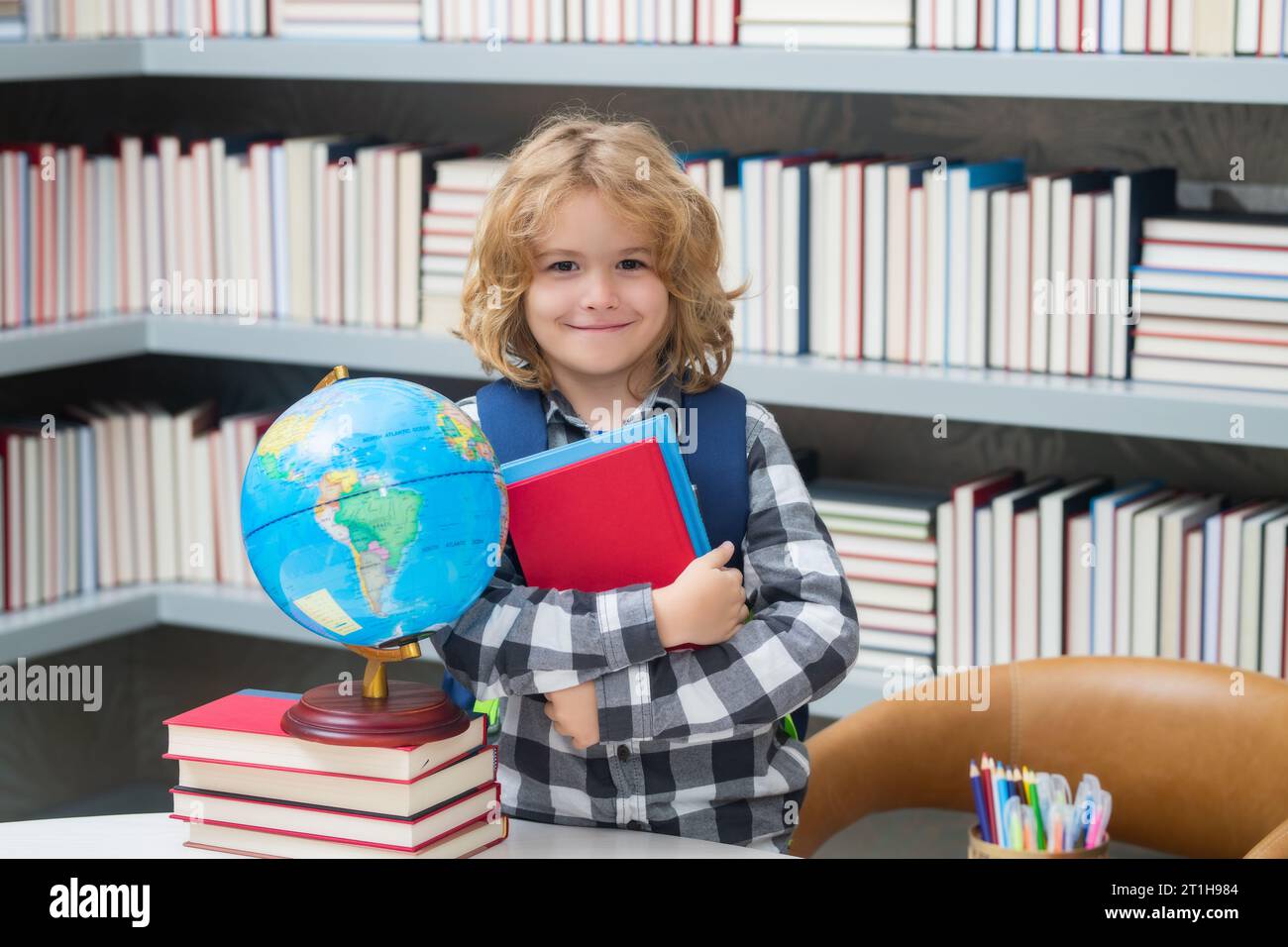 Pupilla nerd. Bambino intelligente della scuola elementare con libro. Intelligenza geniale intelligente capretto pronto per imparare Foto Stock
