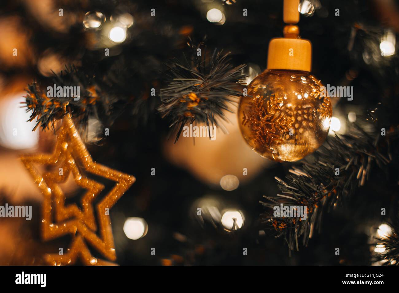 Albero di Natale decorato con un giocattolo di Natale dorato e lucente con stelle dorate. Festeggiamenti invernali. Sfondo invernale magico per Capodanno Foto Stock