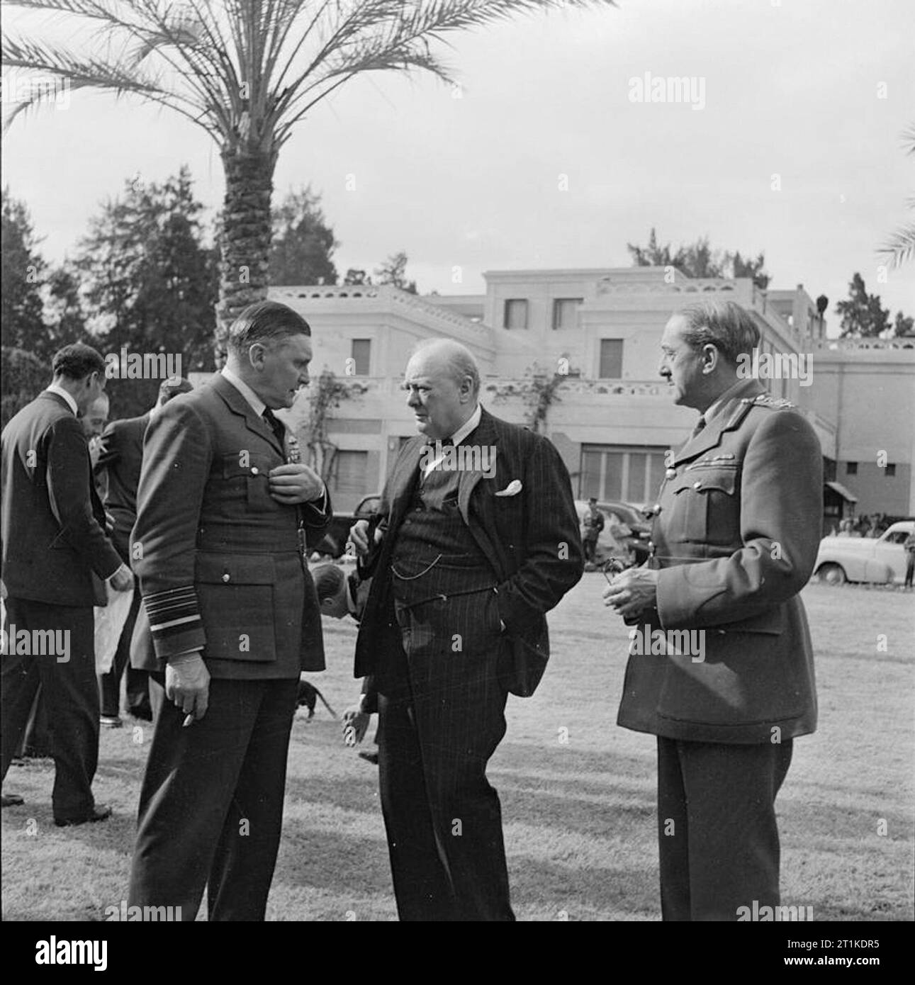 Winston Churchill durante la Seconda Guerra Mondiale in Nord Africa Winston Churchill in conversazione con AIR CHIEF MARSHAL Sir Sholto Douglas e il generale Sir Alan Brooke, Capo del generale imperiale personale (CIGS) nel giardino dell'Ambasciata Britannica al Cairo nel mese di agosto 1942. Foto Stock