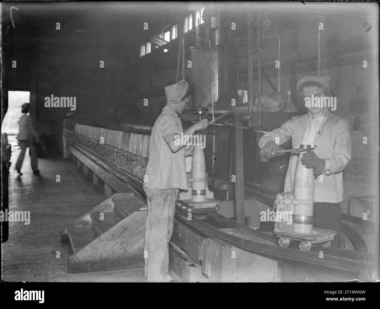 La Royal Navy durante la Seconda guerra mondiale le donne che lavorano nella shell-camera di verniciatura presso il Royal Naval Armament Depot a Priddy's Hard. Ogni guscio è posto su un singolo carrello fissato alle rotaie lungo il lato della stanza. Foto Stock