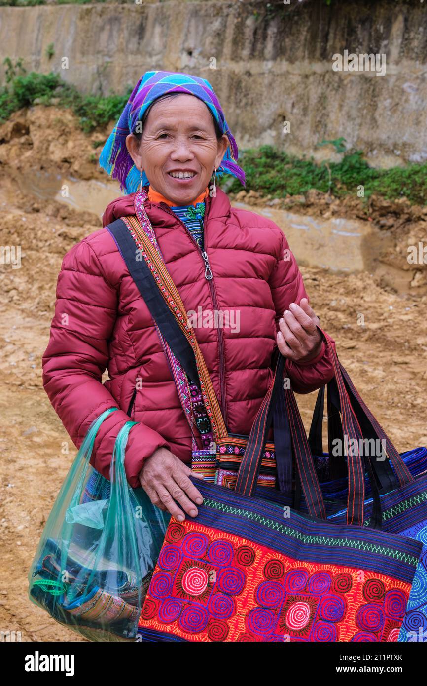 CAN Cau Market Scene, Vietnam. Hmong Woman vende borse e borse. Provincia di Lao Cai. Foto Stock