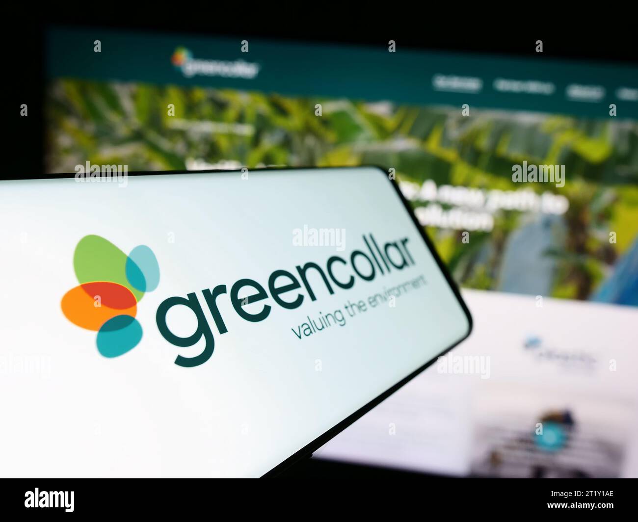 Smartphone con logo della società di investimento australiana GreenCollar Group davanti al sito Web aziendale. Mettere a fuoco il display centrale sinistro del telefono. Foto Stock