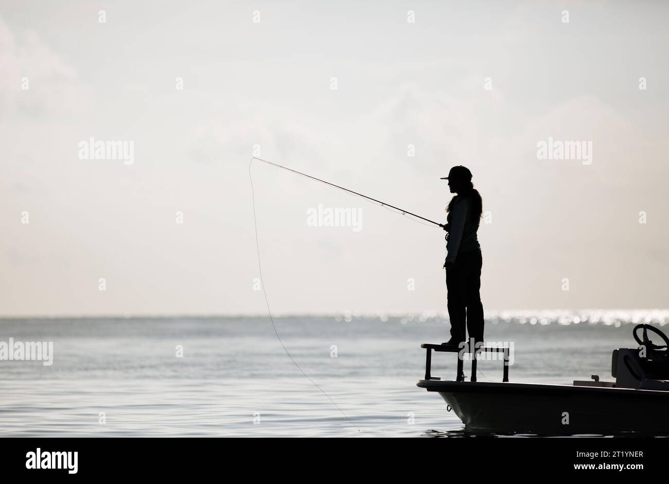 Donna che pesca dalla barca Foto Stock