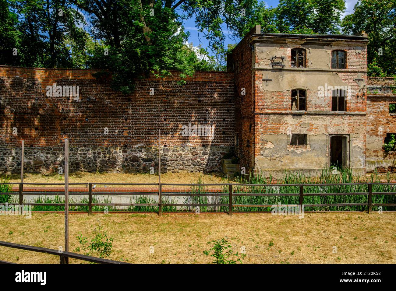 Edificio abbandonato e fatiscente integrato nel vecchio muro storico della città di Namyslow (Namslau), voivodato di Opole, Polonia. Foto Stock