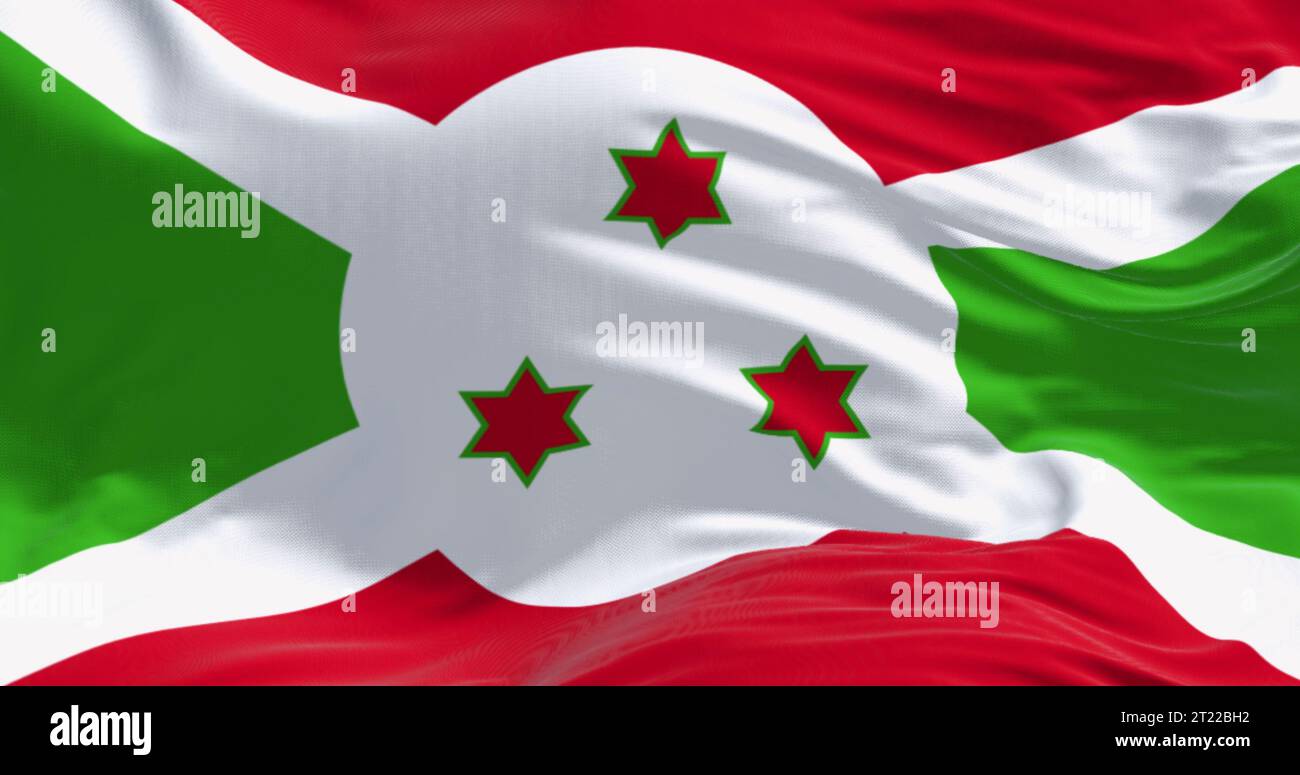 Primo piano della bandiera nazionale del Burundi che sventola in una giornata limpida. Croce diagonale bianca che si divide in sezioni rosse e verdi, tre stelle verdi al centro. 3 Foto Stock
