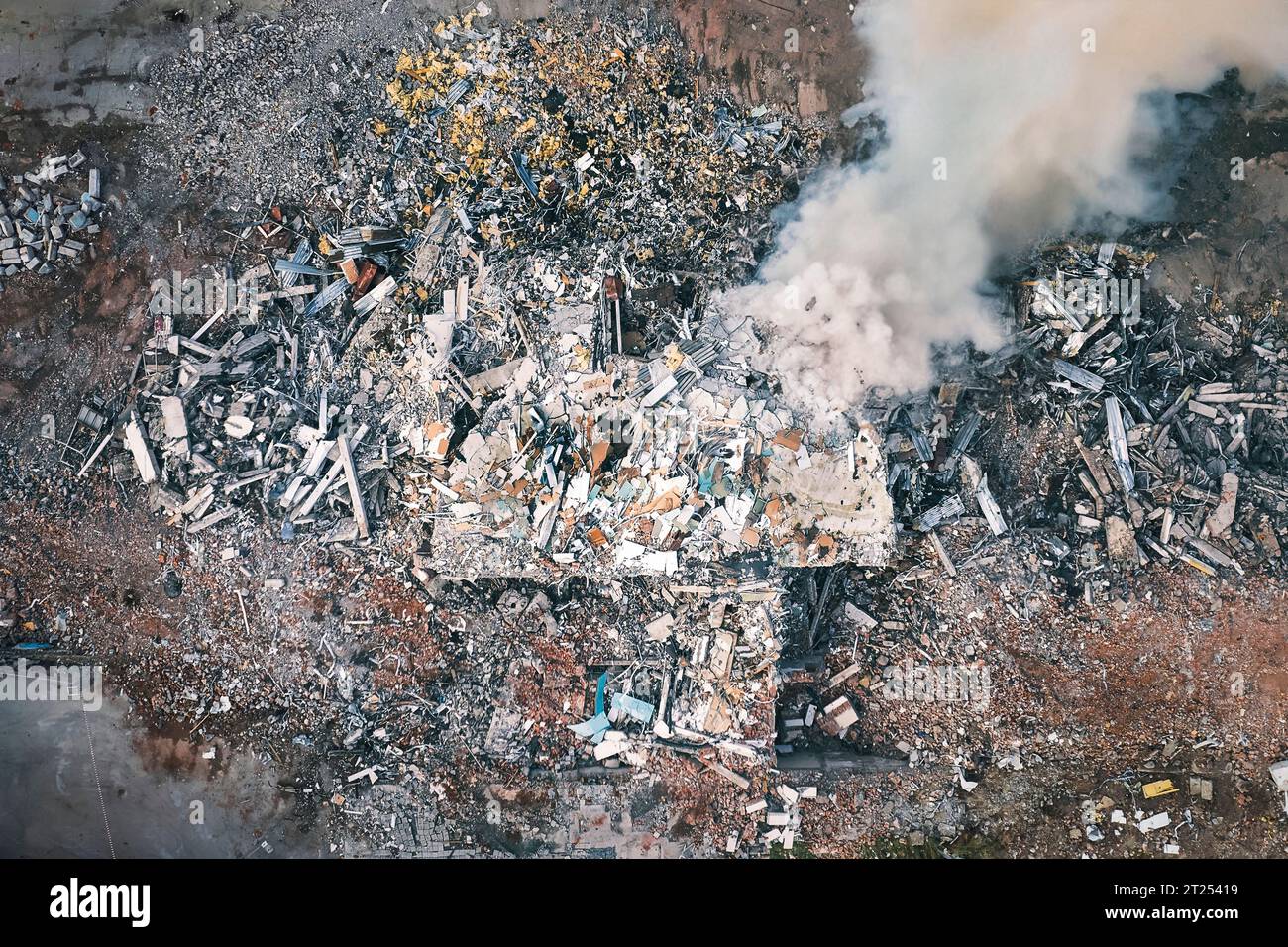 Vista dall'alto dell'edificio distrutto. Vista aerea delle rovine. fumo dalla vista aerea dell'edificio distrutto. Vista dall'alto e ripresa dal drone. Foto Stock