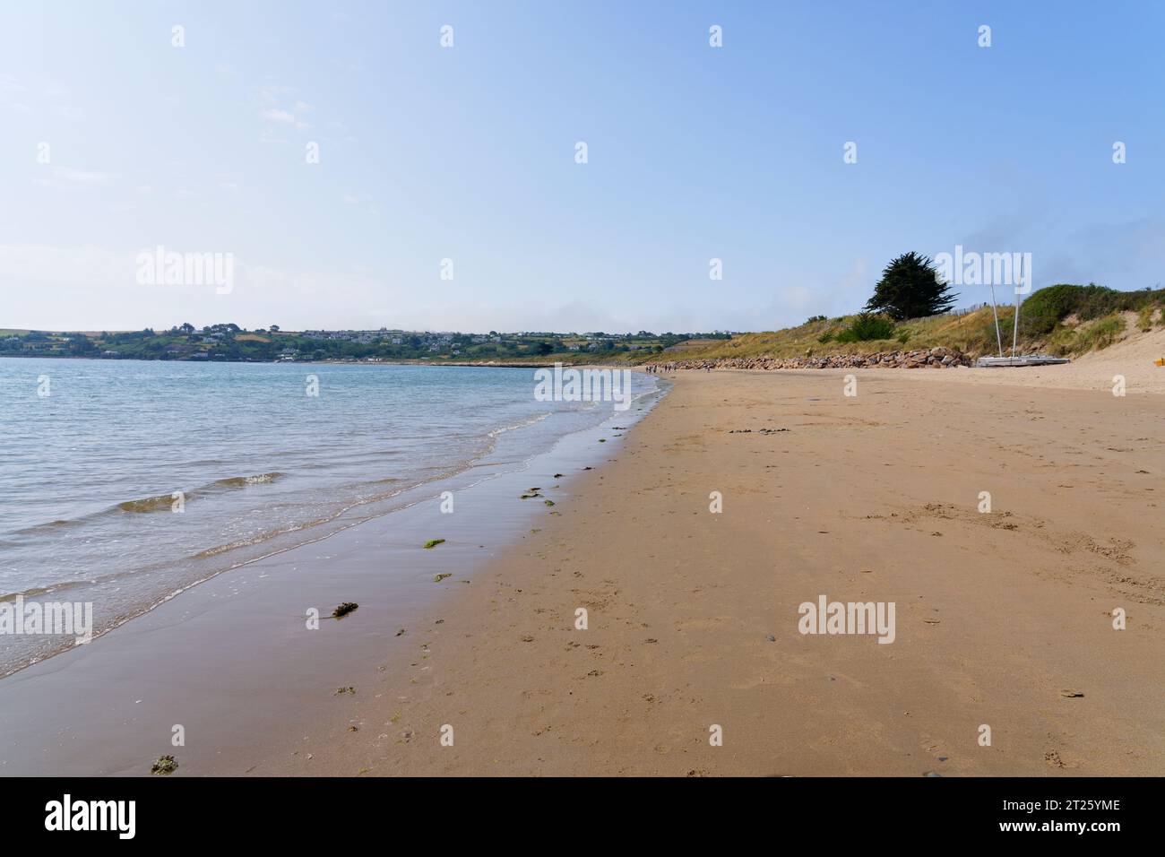 La spiaggia di Abersoch è quasi deserta, ad eccezione di un piccolo numero di persone indistinte in lontananza. Foto Stock