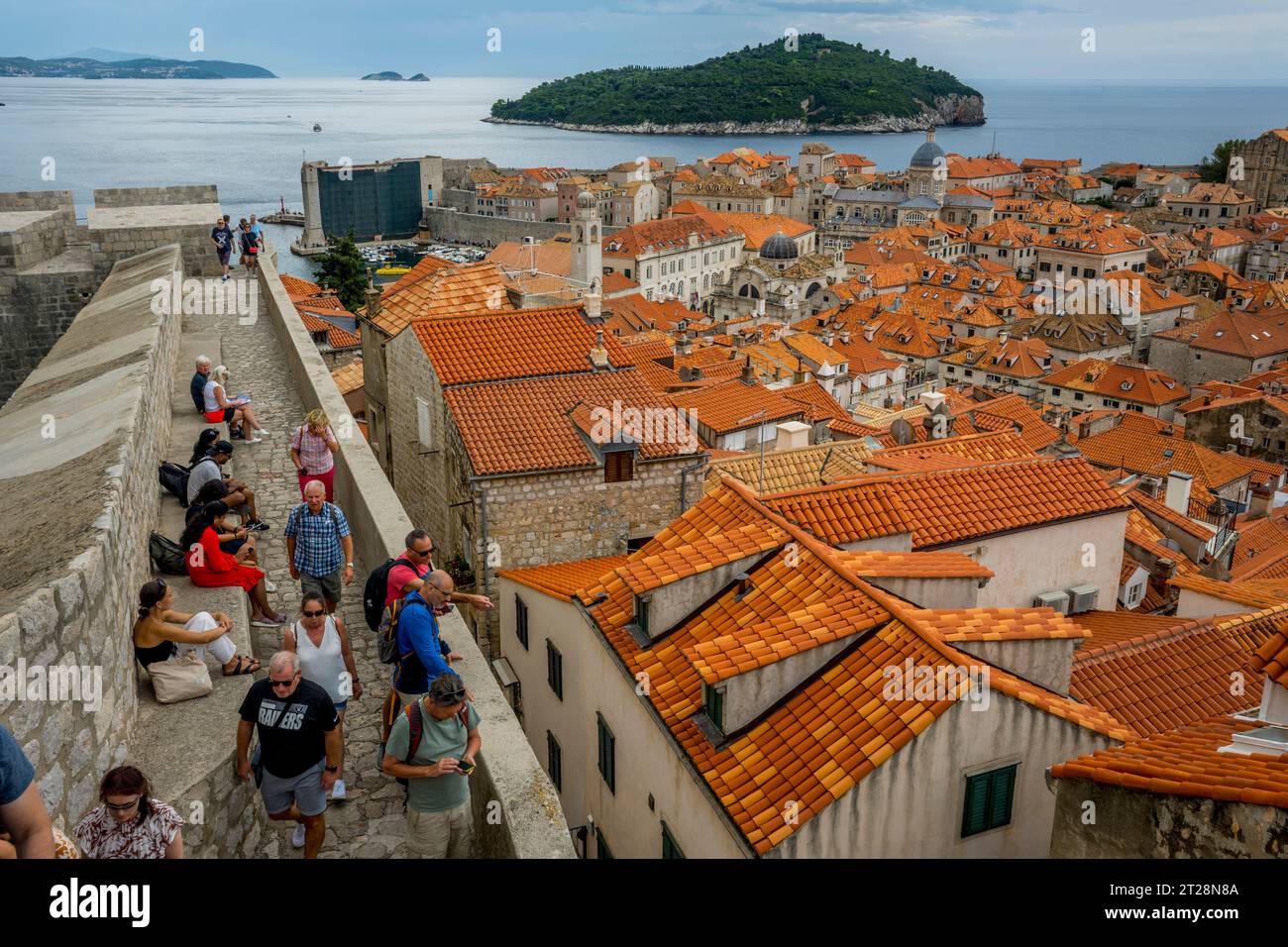 I turisti sulle mura della città passeggiano intorno alla città vecchia di Dubrovnik, nella Croazia meridionale. Foto Stock