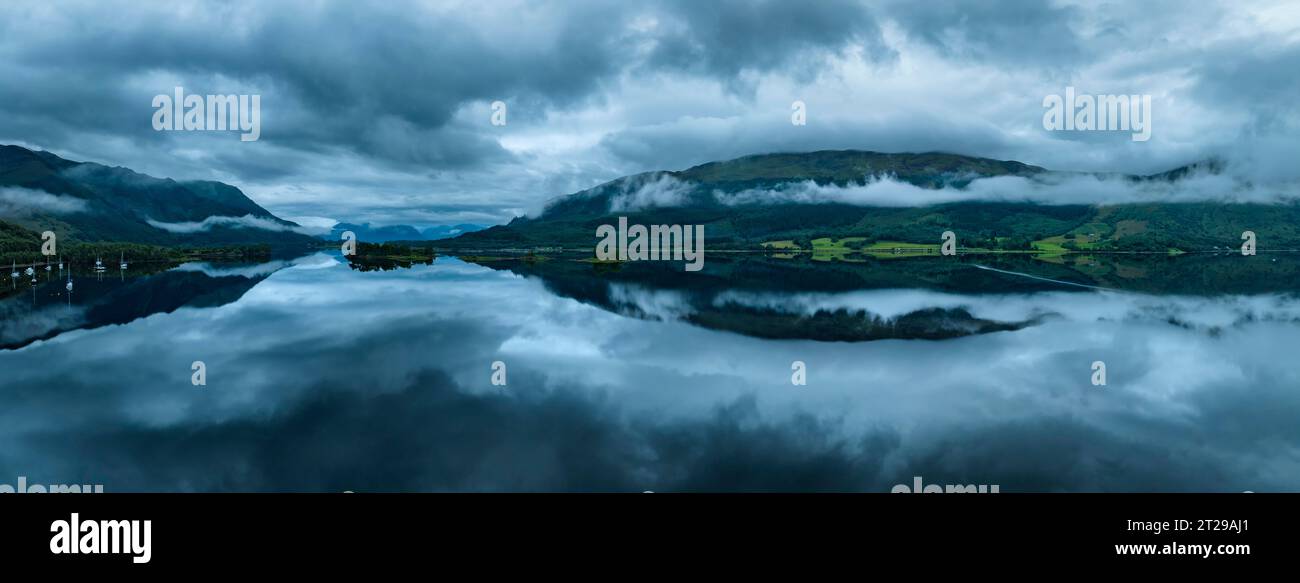 Panorama aereo, atmosfera mattutina con riflessi d'acqua sulle acque dolci di loch Loch Leven, Glen Coe Village, Highlands, Scozia, Gran Bretagna Foto Stock