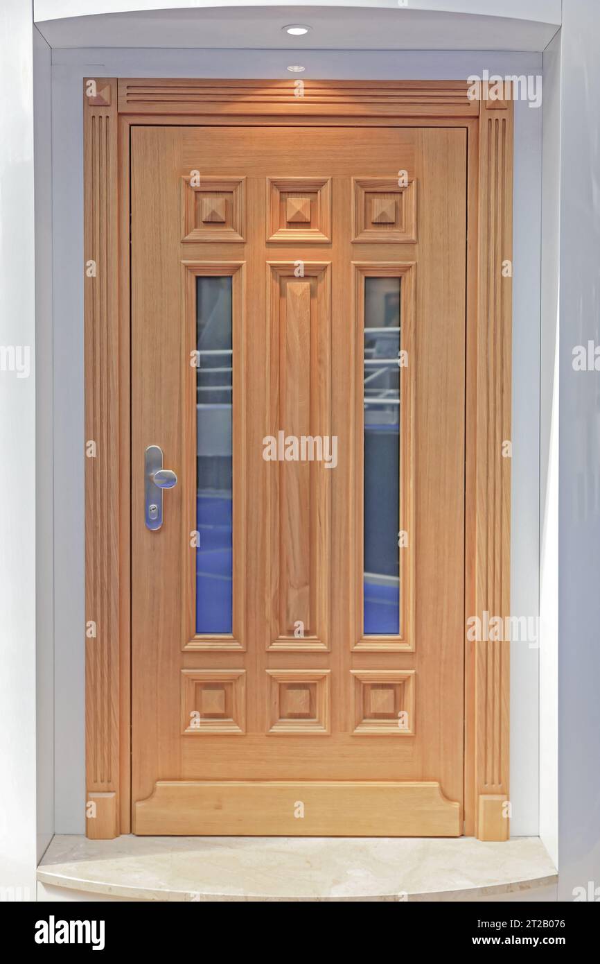 Porta in legno di stile classico con finestre verticali che aprono l'ingresso della casa Foto Stock