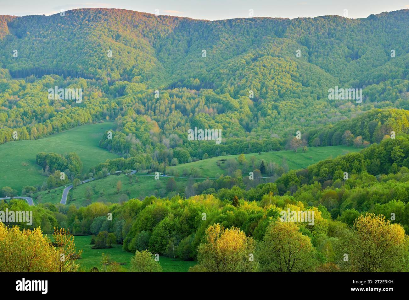 Magnifica vista della valle e della cresta montana illuminata dal sole che tramonta Foto Stock