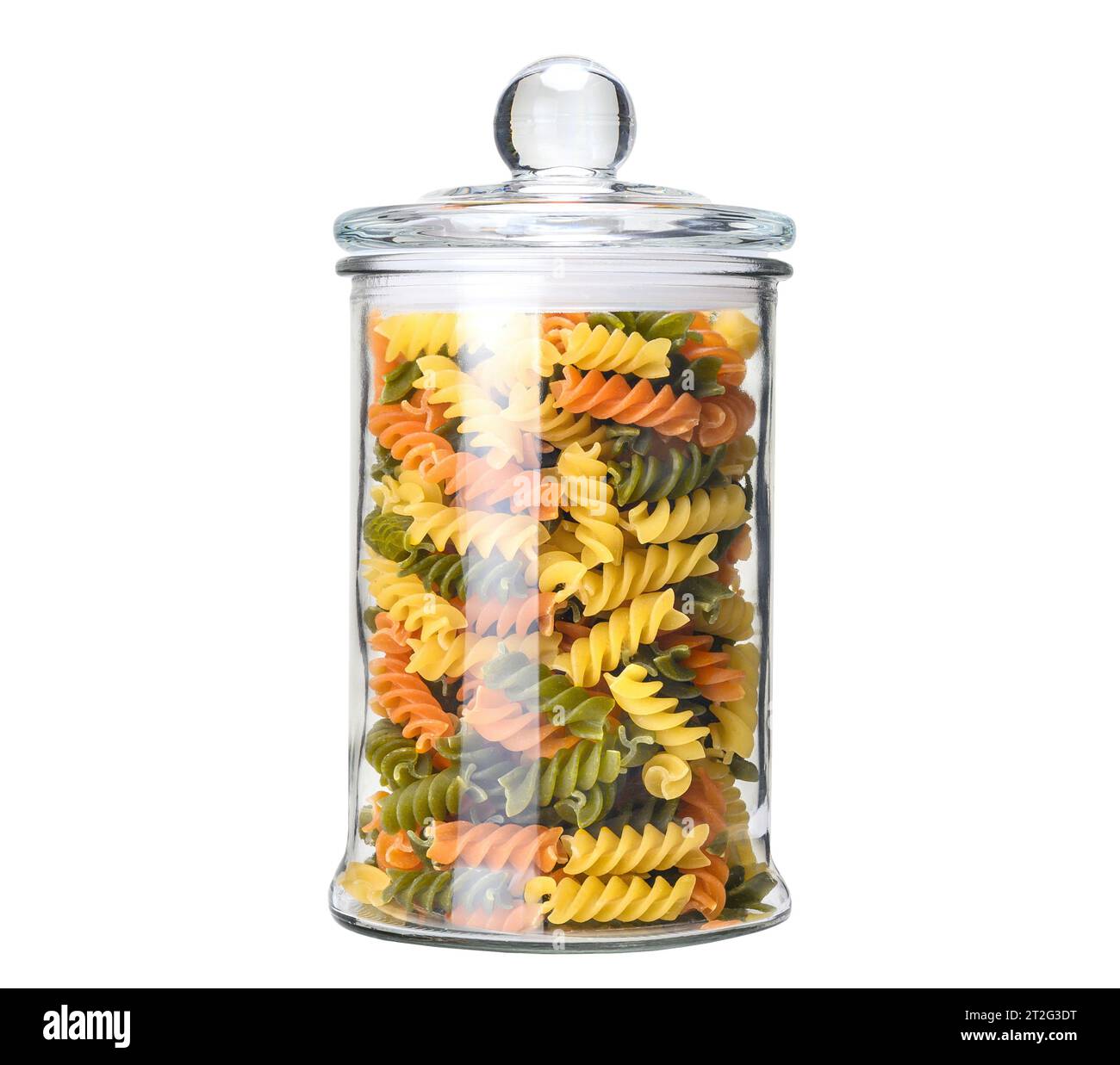Vaso di vetro con pasta rotini mista, pasta rossa, gialla e verde Foto Stock