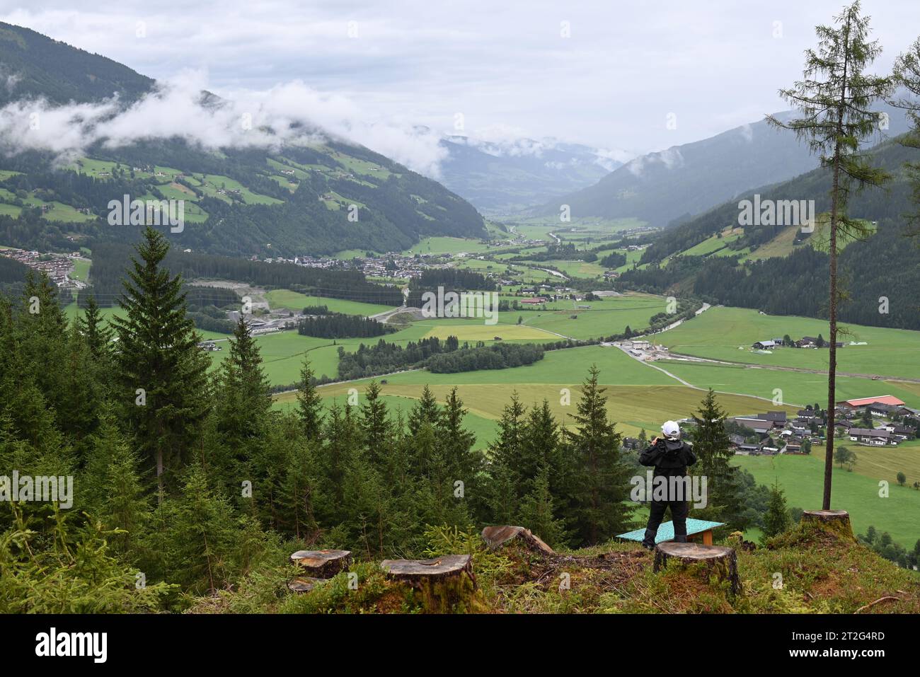 Donna anziana che guarda la vista della valle sotto il villaggio di Neukirchen Salisburgo Austria. Foto Stock