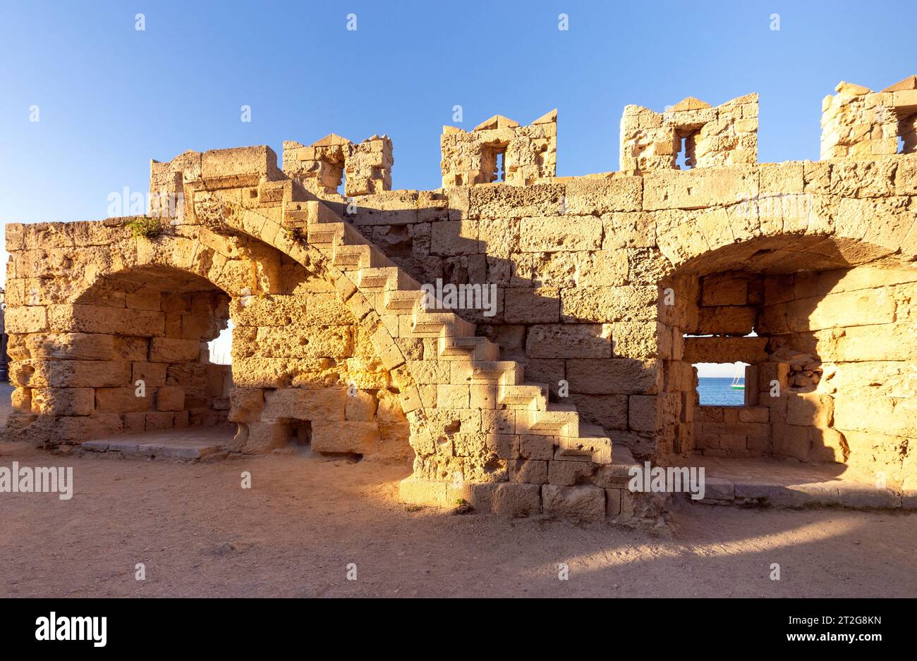 Vista delle scale sulle mura della vecchia fortezza in pietra sull'isola di Rodi. Grecia. Foto Stock
