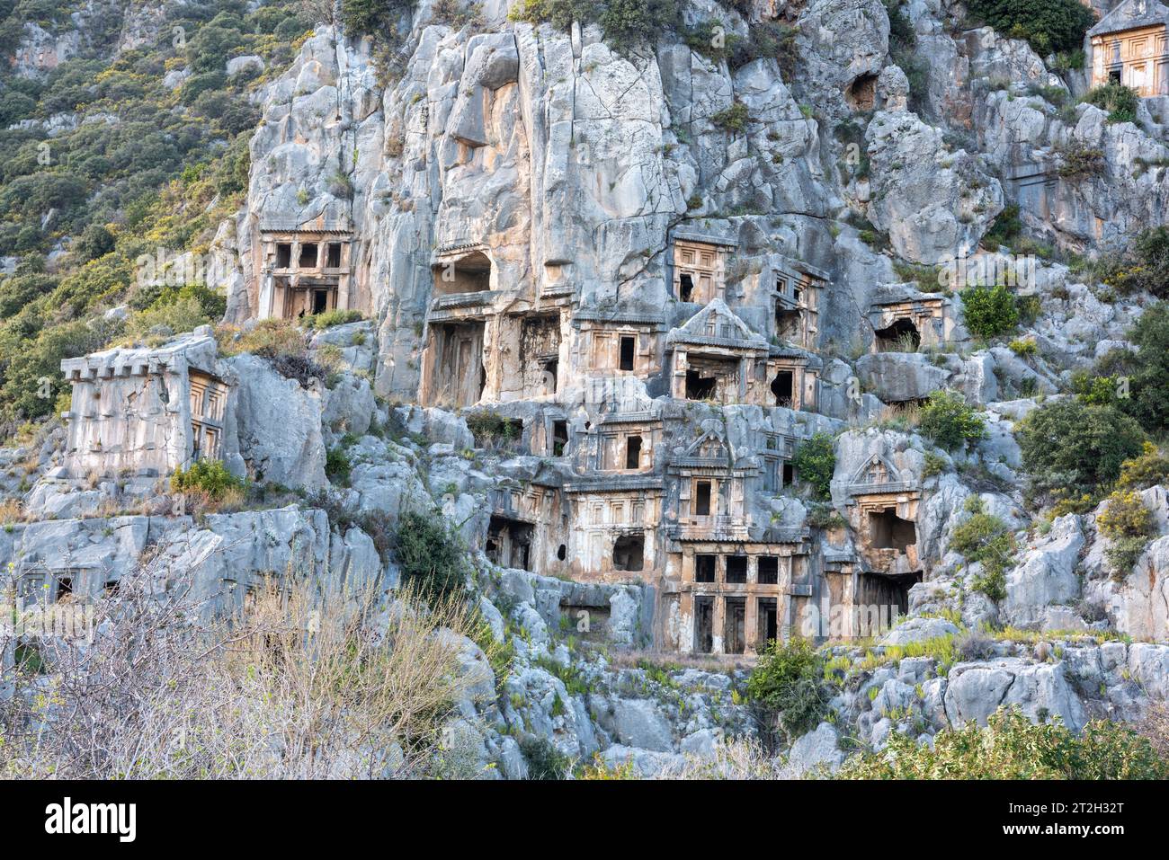 Tombe di roccia Licia di Myra antico sito nella provincia di Antalya in Turchia. Le tombe liache scavate nella roccia sono nella forma di fronti del tempio scolpiti nella verticale Foto Stock