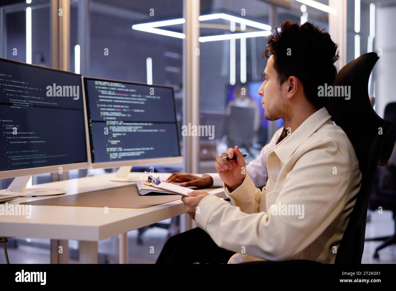 Programmatore di computer che scrive il codice di programma sul computer in Office Foto Stock