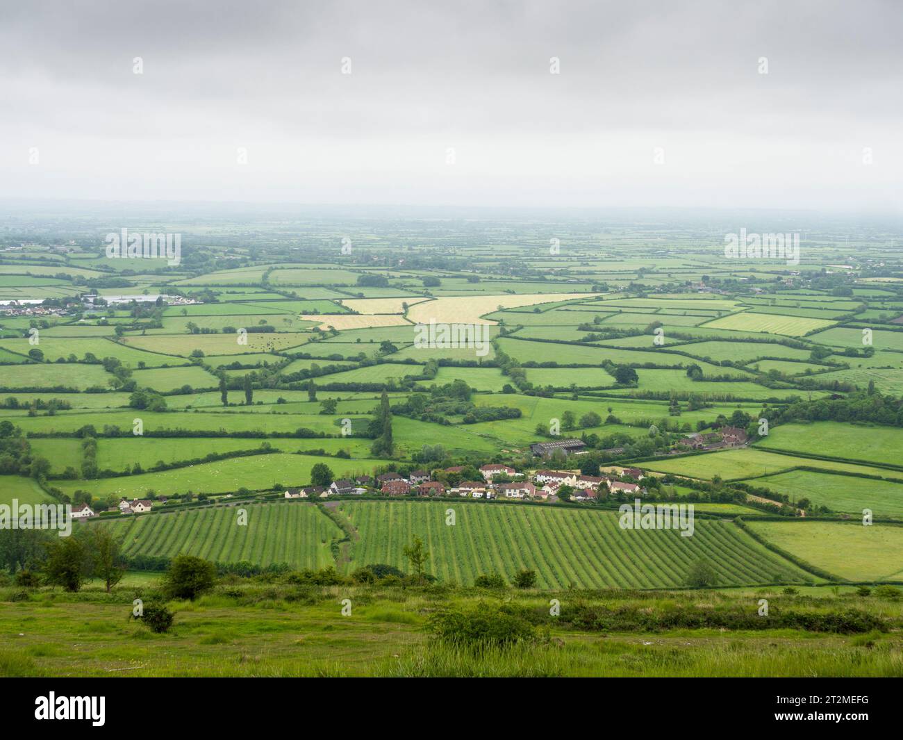 Il villaggio di Cross Below si stende sulle Mendip Hills con i livelli del Somerset oltre, Inghilterra. Foto Stock