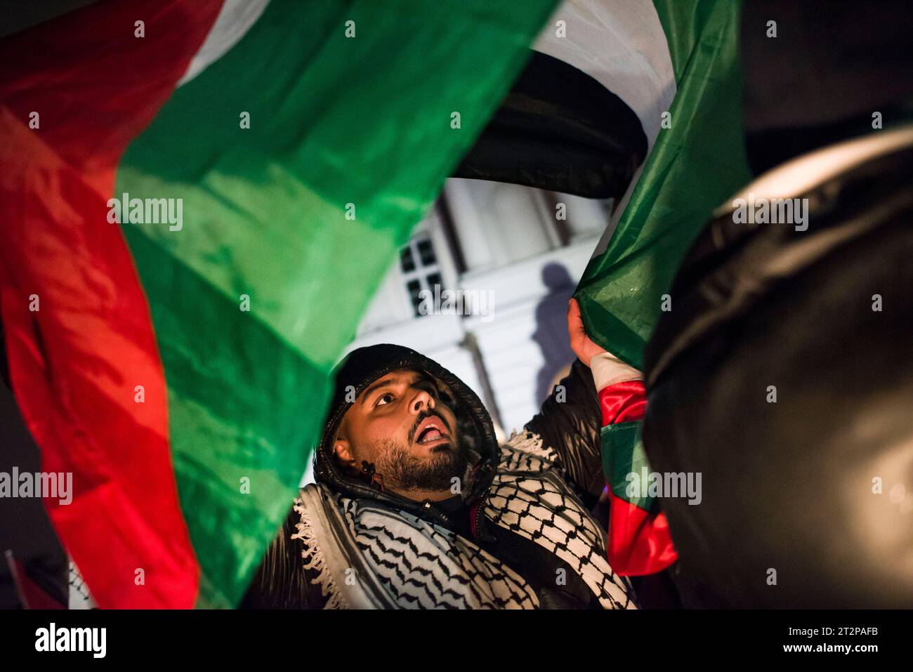 Il manifestante canta slogan mentre sventola una bandiera palestinese durante la manifestazione pro-palestinese a Varsavia. Centinaia di persone - tra cui palestinesi - si sono riunite sotto la pioggia battente nel centro di Varsavia per protestare con lo slogan "Smettila la pulizia etnica a Gaza”. I manifestanti pro-palestinesi chiedono la fine dei bombardamenti civili a Gaza da parte di Israele, l'apertura dei corridoi umanitari e la fornitura di cibo, acqua e medicine agli abitanti della Striscia di Gaza. I manifestanti hanno cantato slogan come "Palestina libera” o "Israele è uno Stato terrorista”. Foto Stock