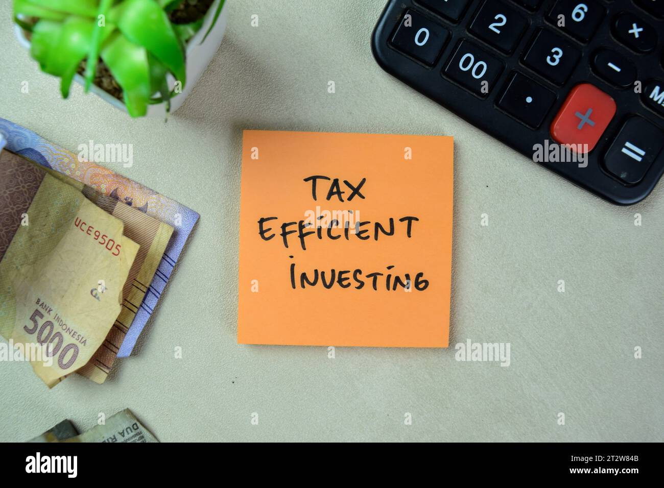 Concetto di investimento efficiente in termini fiscali scrivere su appunti isolati su tavola di legno. Foto Stock