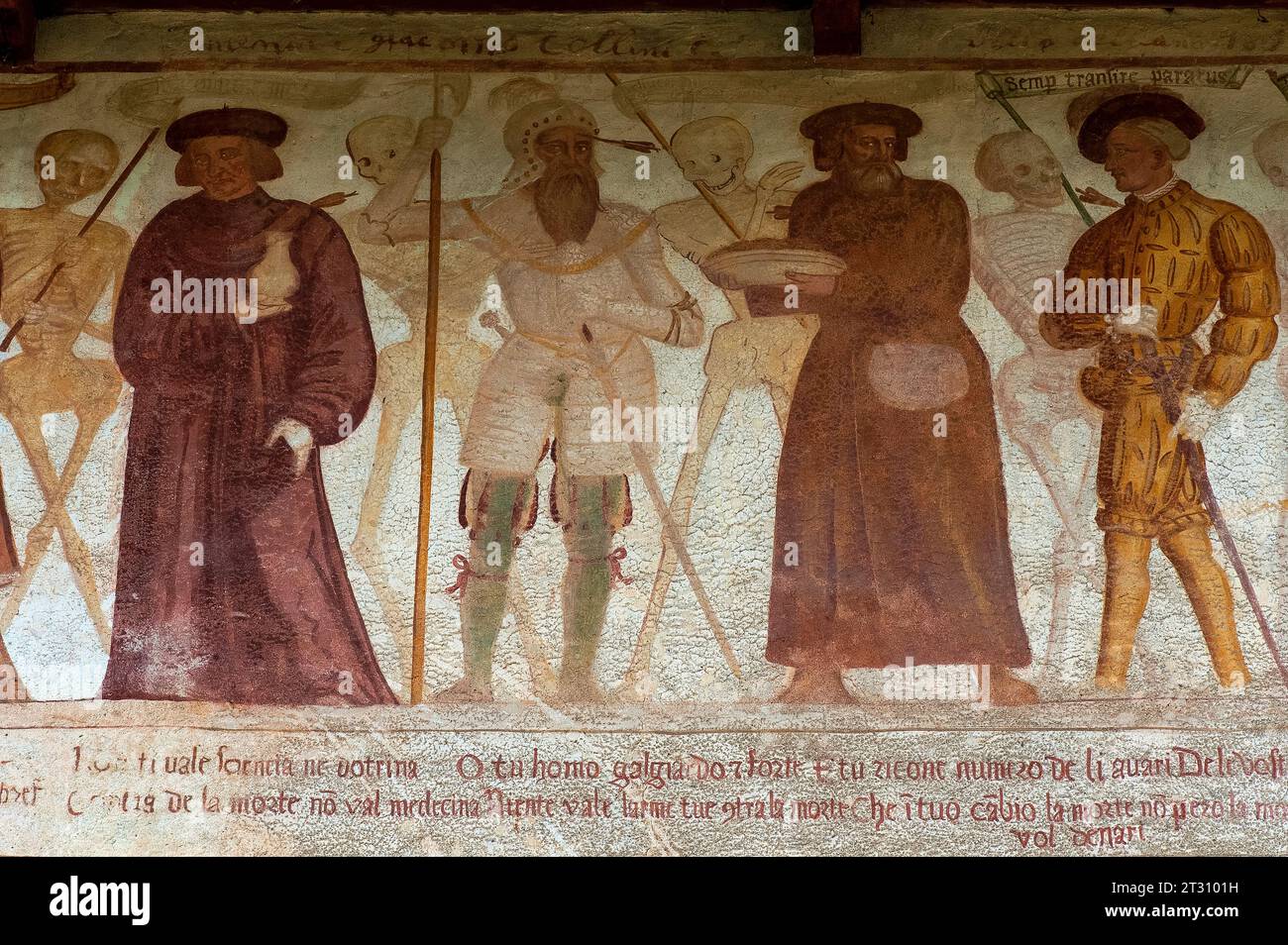 Scheletri sorridenti con quattro uomini, ciascuno forato dalla freccia della morte: Un uomo che trasporta un barattolo; un soldato in armatura; un uomo con un grande berretto piatto rotondo; e un uomo ben vestito in doppietto tagliato, tubo del tronco e maniche gonfiate, con un colletto in pizzo e piuma nel suo cappello. Particolare del fregio rinascimentale Danza Macabra, dipinto nel 1539 da Simone II Baschenis (c. 1495-1555) su una parete esterna della Chiesa di San Vigilio, Pinzolo, Trentino-alto Adige. Il fregio ha didascalie nei dialetti locali e nella lingua compresa dalla gente comune. Foto Stock