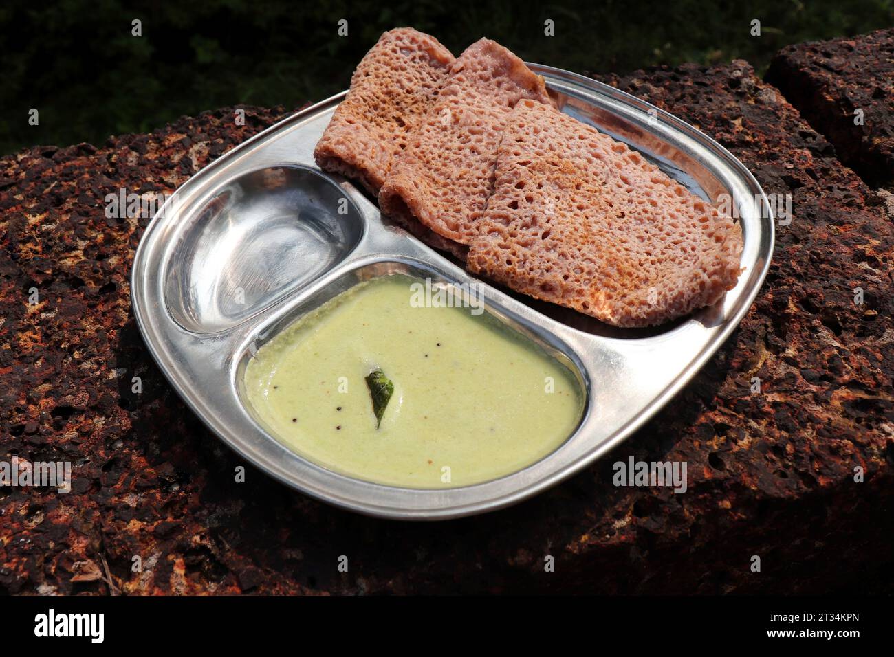 Il Ragi Ghavne and chutney, o Neer dose, è un popolare piatto per la colazione della cucina Konkani o dell'India meridionale. Ghavne è una crepa di raagi sottile e delicata Foto Stock