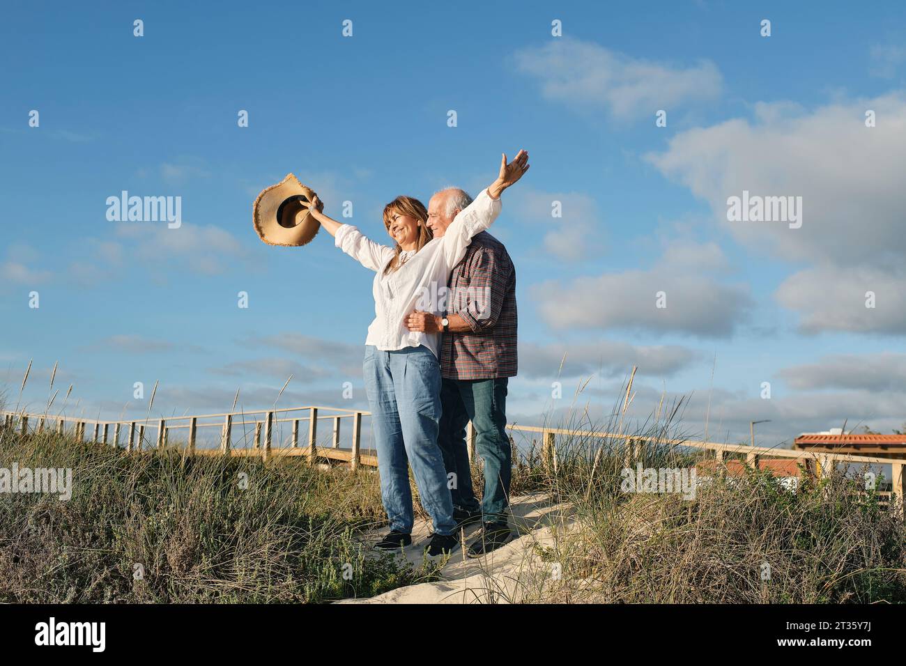 Felice coppia anziana che si gode insieme sotto il cielo nuvoloso nella giornata di sole Foto Stock