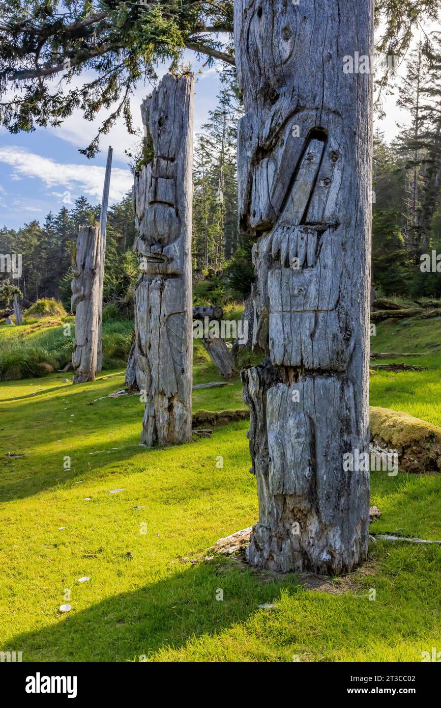 Pali totemici presso Sgang Gwaay Llnagaay, sito patrimonio dell'umanità dell'UNESCO, un antico villaggio nel parco nazionale di Gwaii Haanas, Haida Gwaii, British Co Foto Stock