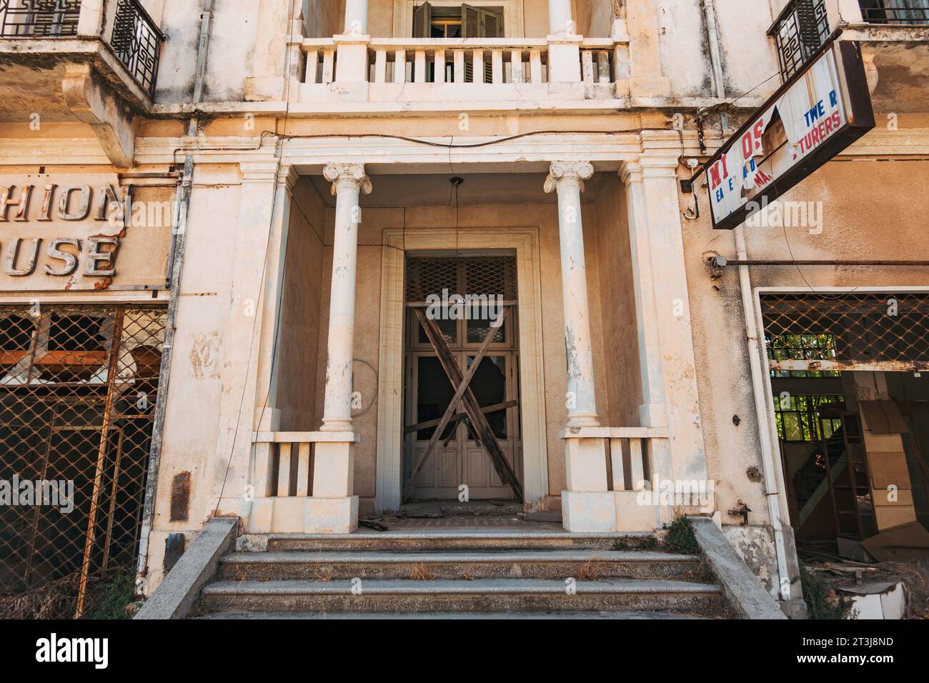 Un vecchio cartello sopra una porta di un negozio di moda a Varosha, un sobborgo della città di Famagosta, Cipro, abbandonato dal 1974 Foto Stock