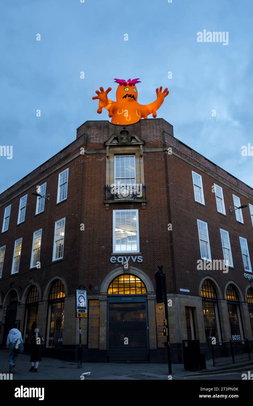 Mostro illuminato arancione sull'edificio eqvvs, all'angolo tra High Street e Clasketgate, Lincoln City, Lincolnshire, Inghilterra, Regno Unito Foto Stock
