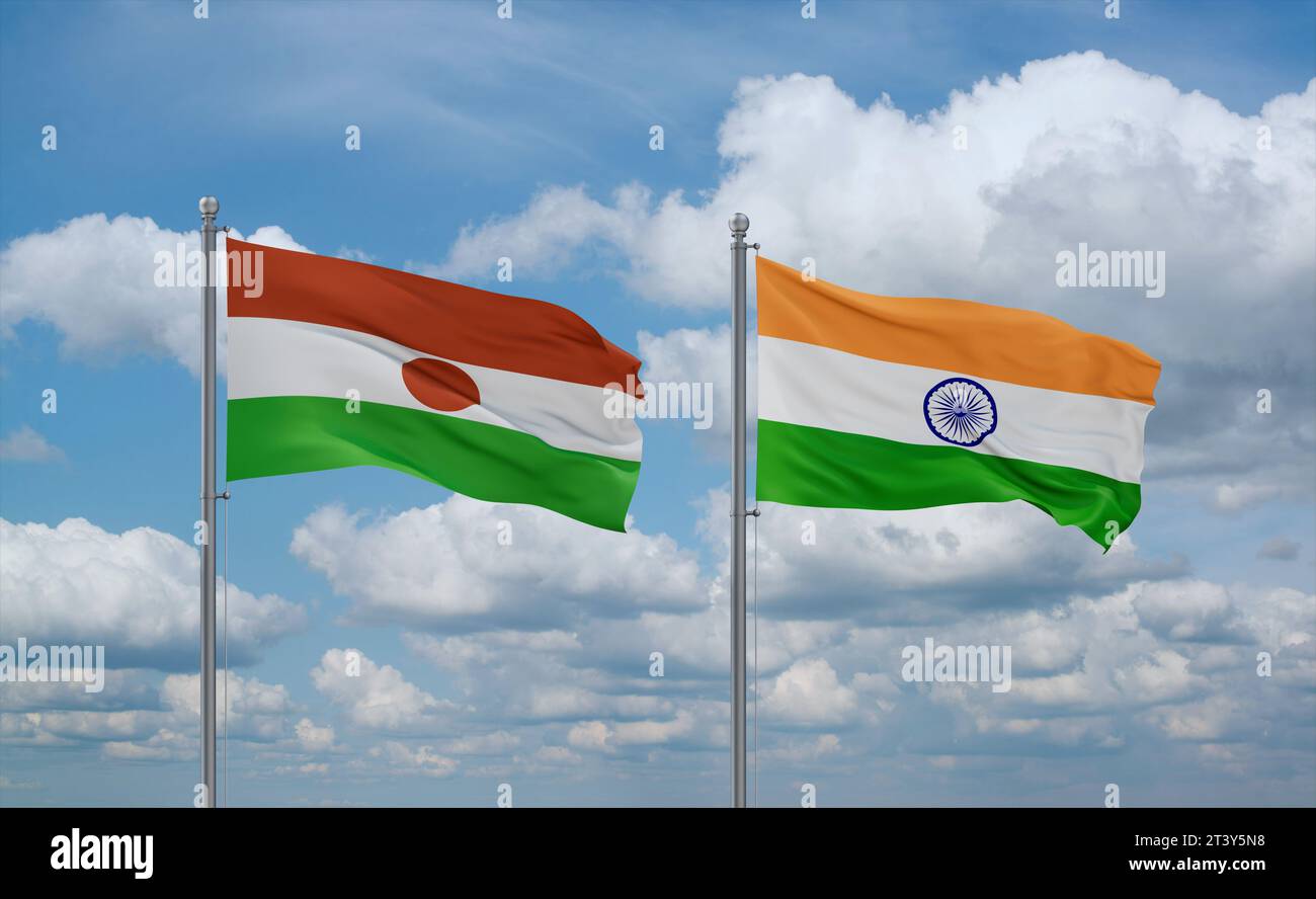 Le bandiere dell'India e del Niger sventolano insieme su un cielo nuvoloso blu, concetto di due relazioni tra paesi Foto Stock