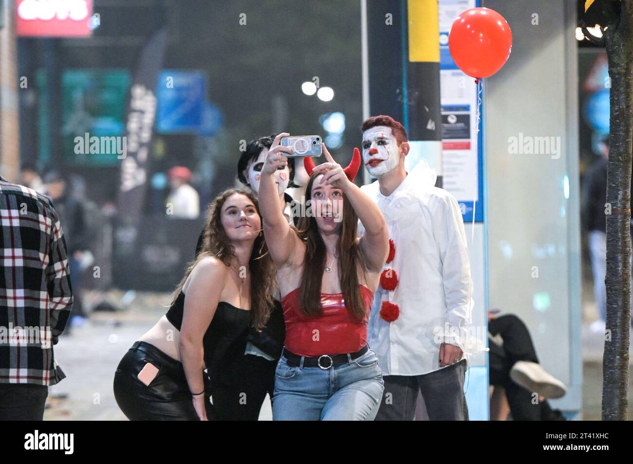 Broad Street, Birmingham, 28 ottobre 2023 - migliaia di festaioli sono andati a Broad Street a Birmingham venerdì sera e sabato mattina. I clubber si vestono da diavoli, agenti di polizia cattivi e altri abiti inquietanti mentre si fanno strada lungo la famigerata striscia dei nightclub. Molti festaioli sembravano un po' peggio per l'abbigliamento, potendo riposarsi su marciapiedi e gradini dopo una lunga serata con gli amici, alcuni si sono divertiti un meritato servizio da asporto prima di prendere un taxi per tornare a casa. La maggior parte era comunque in spiriti gioiosi, nonostante le temperature calassero in figure singole con alcuni abiti molto rivelatori. Altro Foto Stock