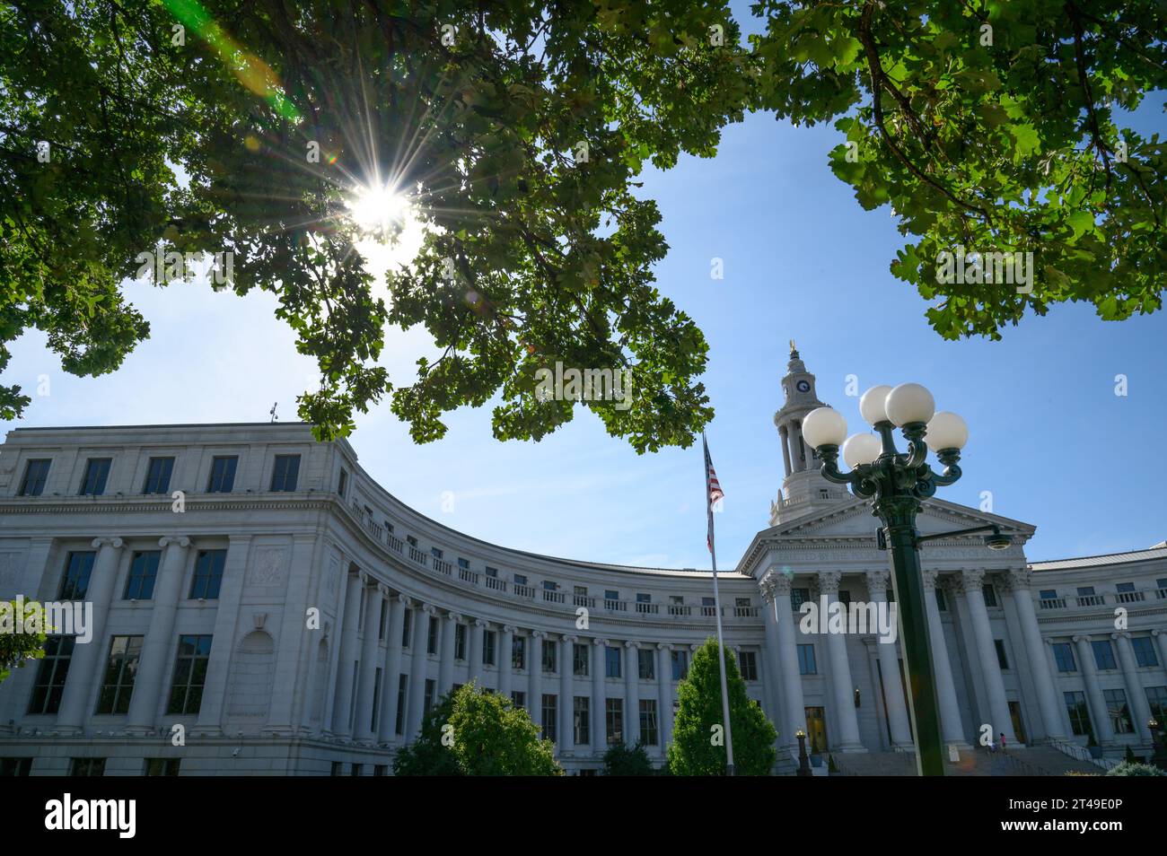 Edificio del Consiglio comunale di Denver con una sunstar che brilla tra gli alberi Foto Stock