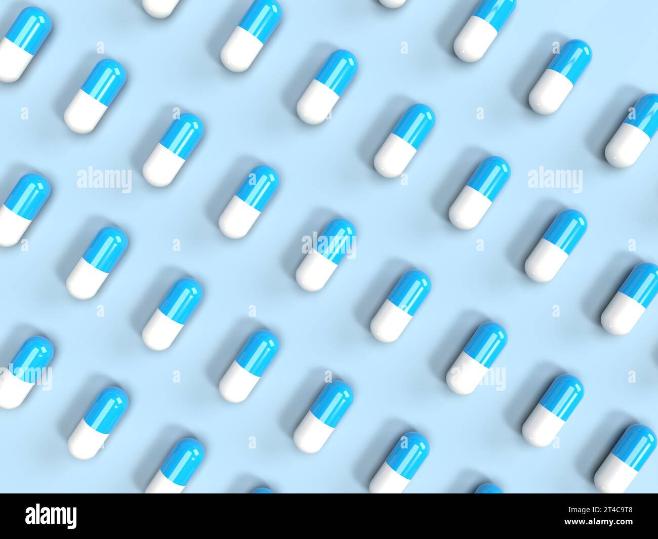 Vista dall'alto delle pillole su sfondo blu allineate di fila. Foto Stock