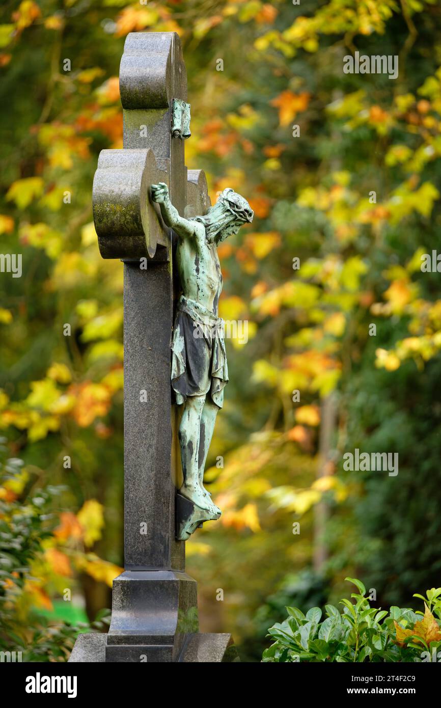 antico crocifisso in un cimitero autunnale a colonia melaten Foto Stock