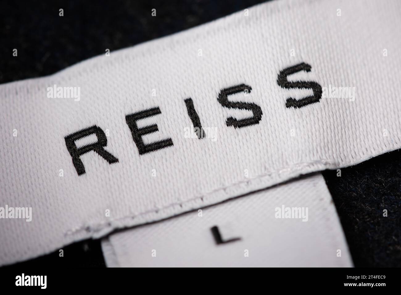Primo piano di un logo Reiss ricamato come si vede su un'etichetta. Foto Stock