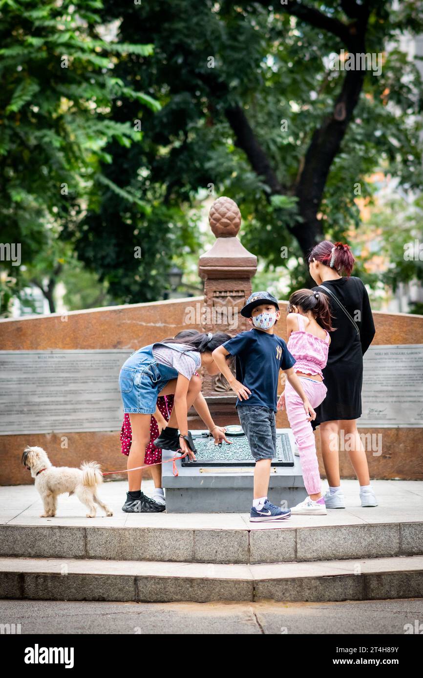 I bambini giocano intorno a una statua nel Rizal Park, Ermita, Manila, Filippine. Foto Stock