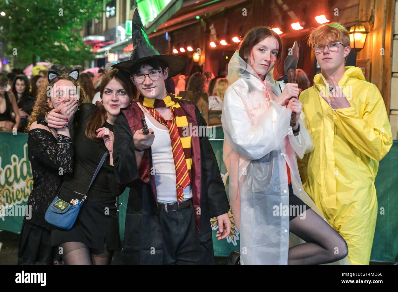 Broad Street, Birmingham, 31 ottobre 2023 - migliaia di festeggiamenti sono usciti martedì sera per festeggiare Halloween. La pioggia ha iniziato a diventare leggera, diventando pesante vicino a mezzanotte, ma ciò non ha smorzato gli spiriti. Alcuni hanno usato cappotti per ripararsi e altri hanno improvvisato con sacchetti di plastica sulla famigerata strada della vita notturna di Birmingham. Il Bier Bar di Heidi era tutto esaurito con una politica "one in, one out" imposta perché le code si estendevano lungo la strada in una delle loro notti più trafficate dell'anno. Nonostante il freddo e il clima umido, ciò non ha impedito alcuni costumi sorprendenti, tra cui un ragazzo con una felpa con cappuccio Just Stop Oil arancione, Una donna dr Foto Stock