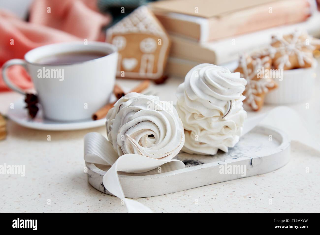 Delicati marshmallow bianchi, cioccolata calda, biscotti allo zenzero e libri a casa. Dessert di Natale. Foto Stock