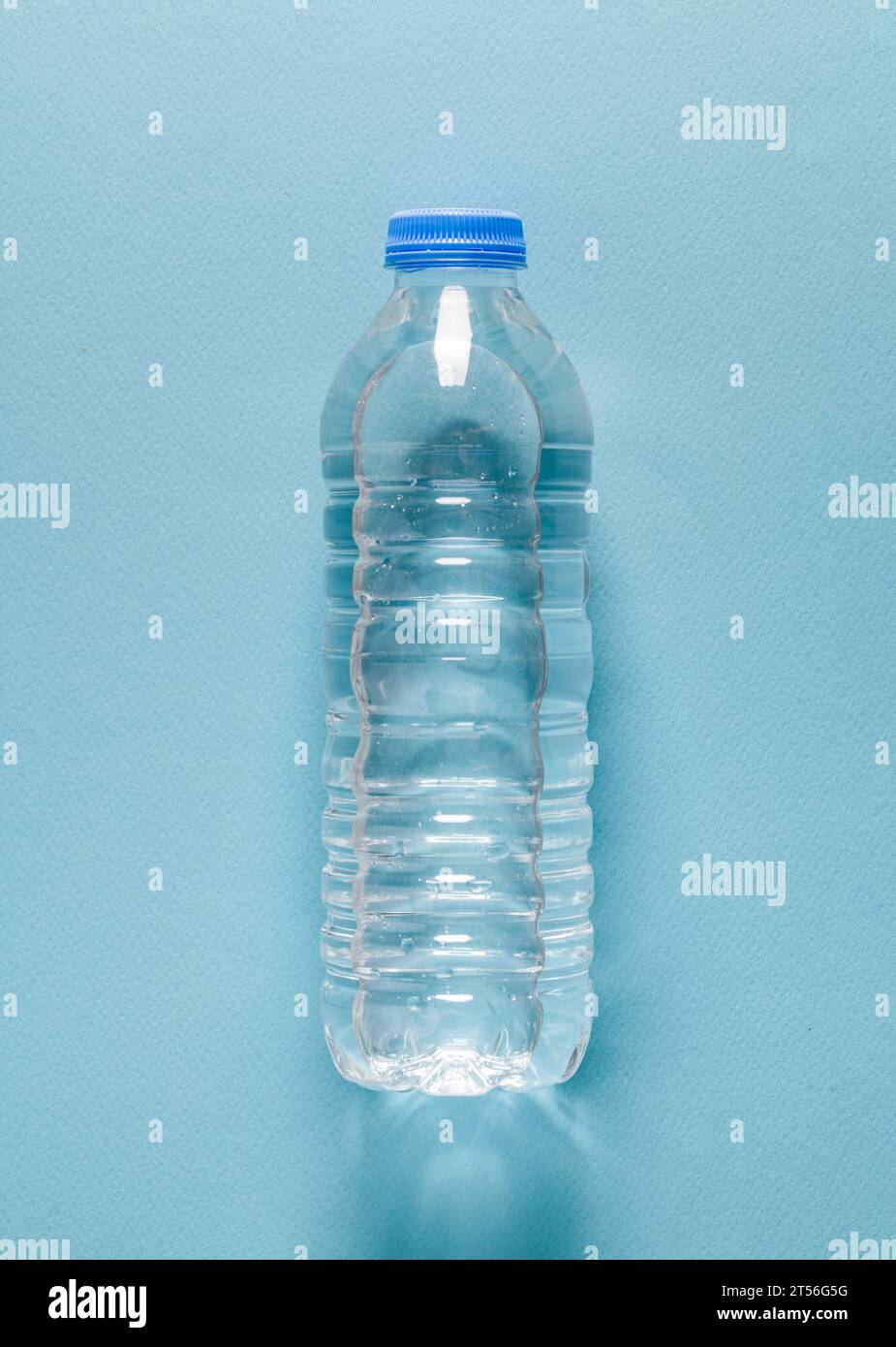 Bottiglia d'acqua in plastica su sfondo blu isolato Foto Stock