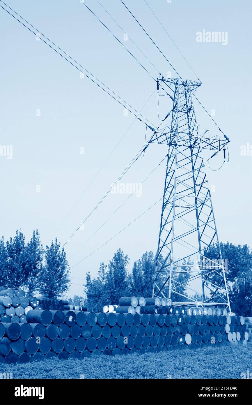 fusti di olio e torre elettrica in un'area di stoccaggio Foto Stock