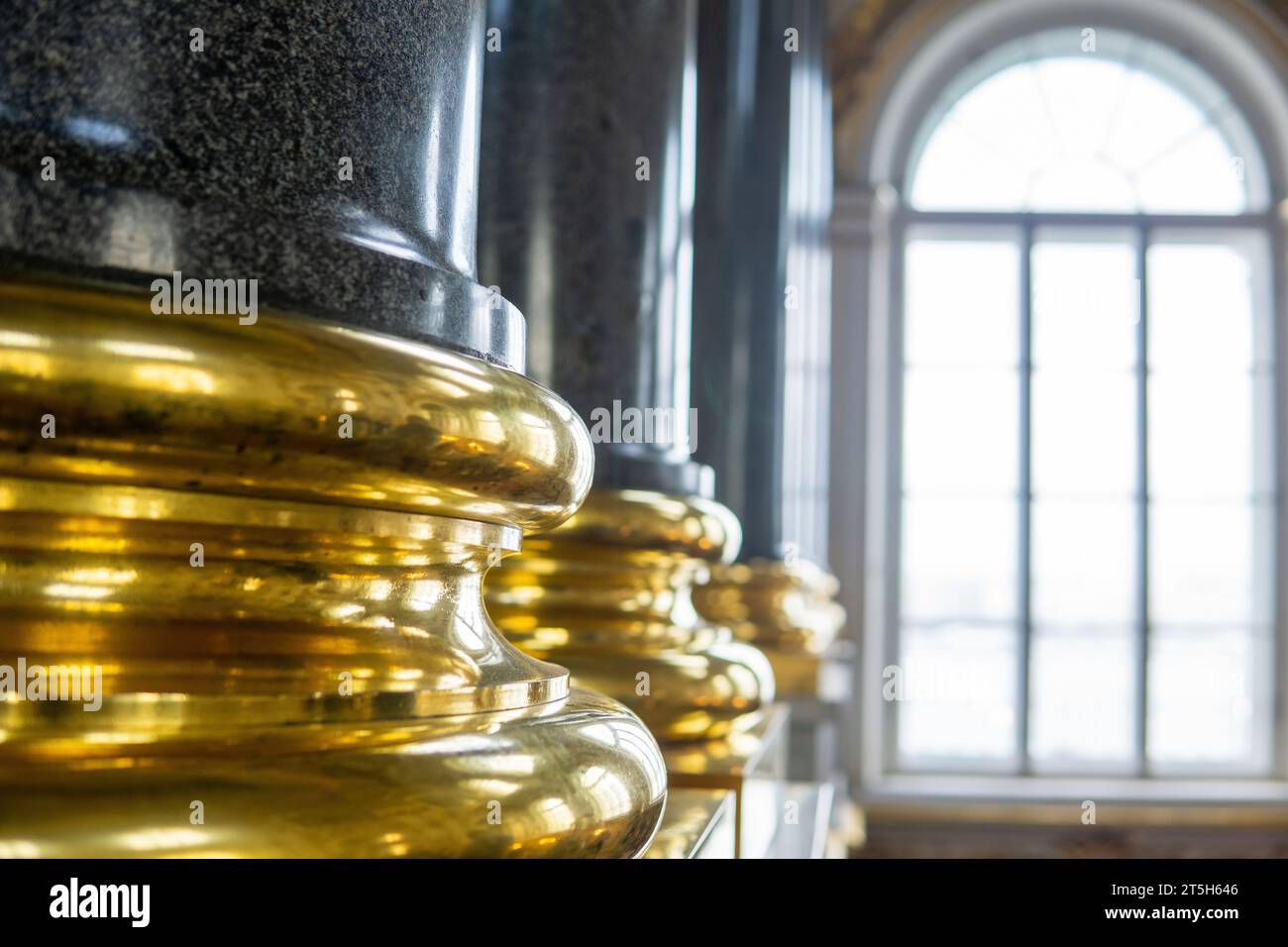 sfondo: interno barocco, fondamenta dorate di colonne di pietra sullo sfondo di una finestra a volta Foto Stock