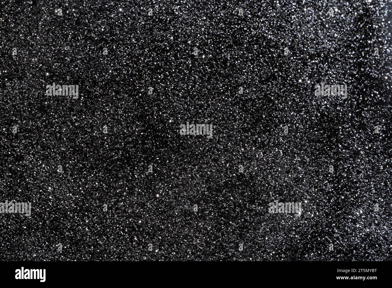 Texture di sfondo brillante con glitter nero. Sfondo astratto sparso per ogni celebrazione Foto Stock