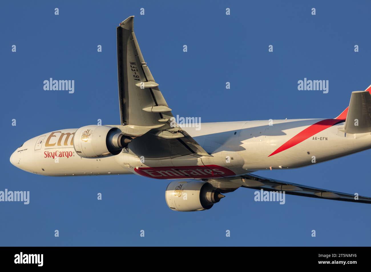 Primo piano di un Boeing 777-F1H Emirates SkyCargo con registrazione A6-EFN, decollo da Londra Heathrow (LHR) in una soleggiata serata autunnale all'ora d'oro Foto Stock