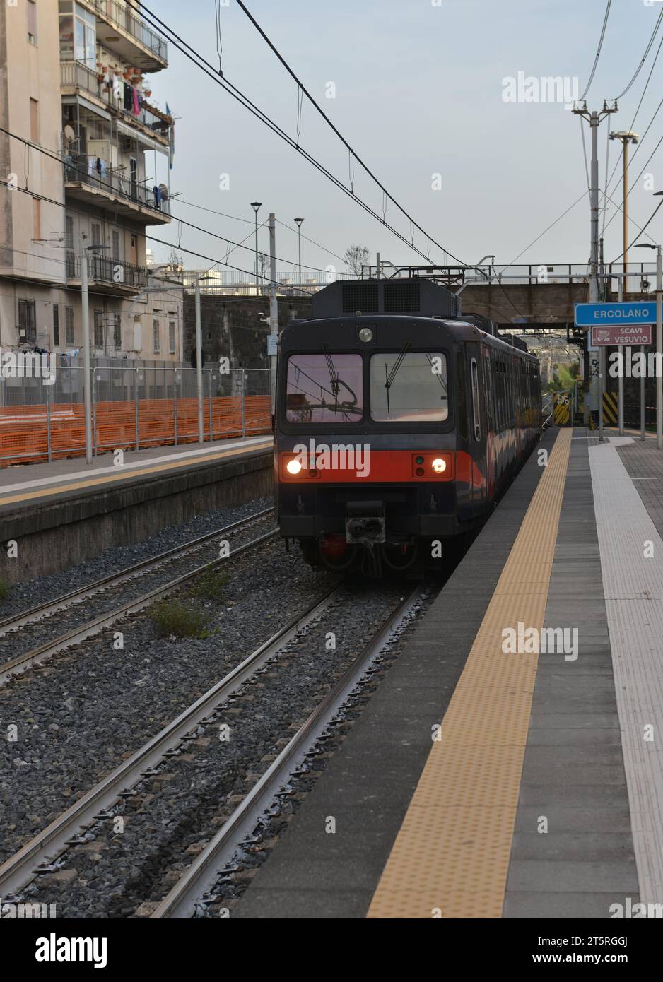 Treno che arriva alla stazione ferroviaria di Ercolano alla periferia di Napoli vicino alle rovine dell'antica Ercolano. Foto Stock
