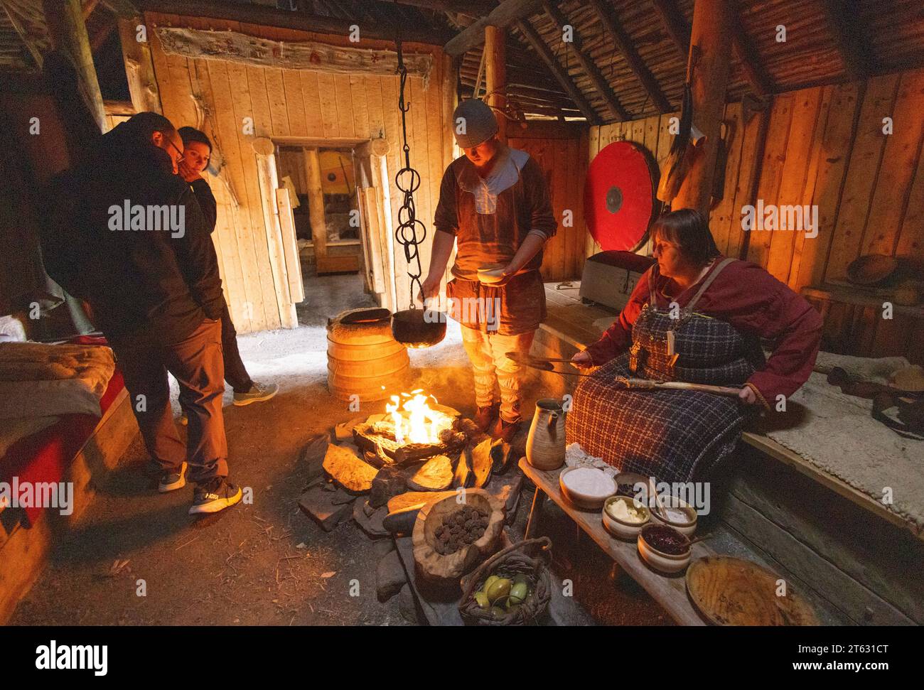 L'anse aux Meadows, sito UNESCO dell'antico insediamento norreno/vichingo, Terranova, Canada. I turisti guardano la ricostruzione interna di attrezzature da cucina Foto Stock